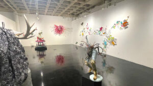 Exhibition of woodsy type art sculptures in a white room