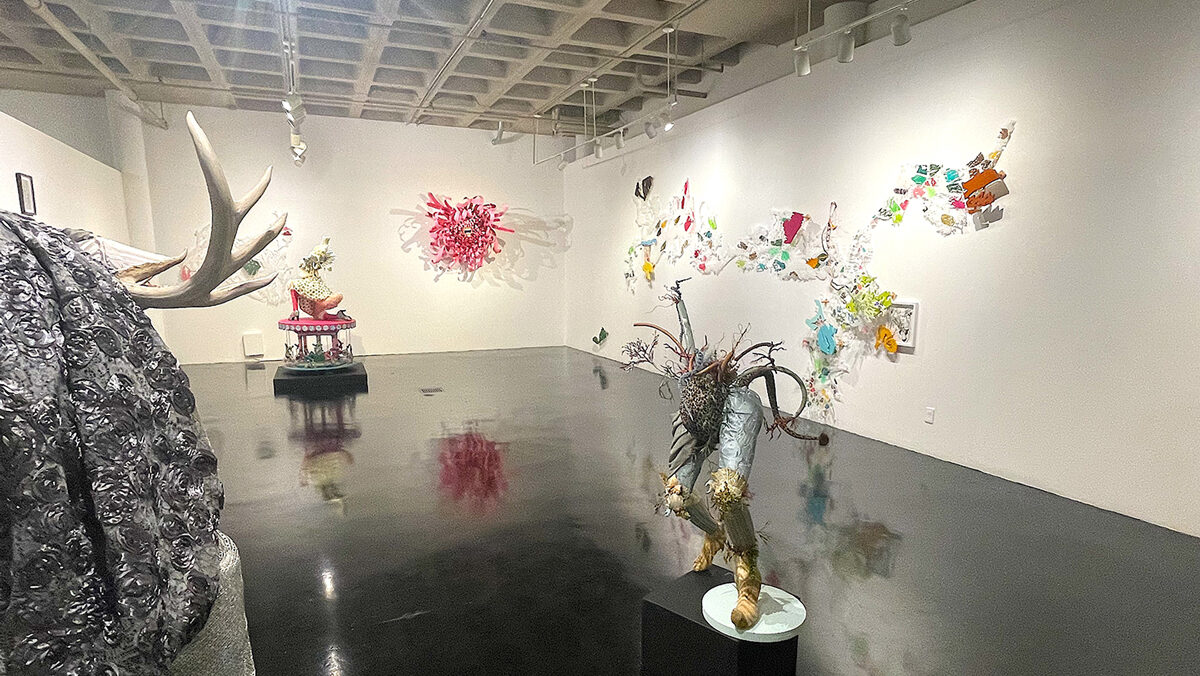 Exhibition of woodsy type art sculptures in a white room